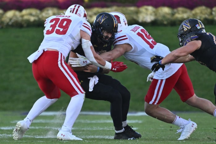 Wisconsin linebacker Tate Grass and Nick Herbig combining for a tackle against Northwestern.